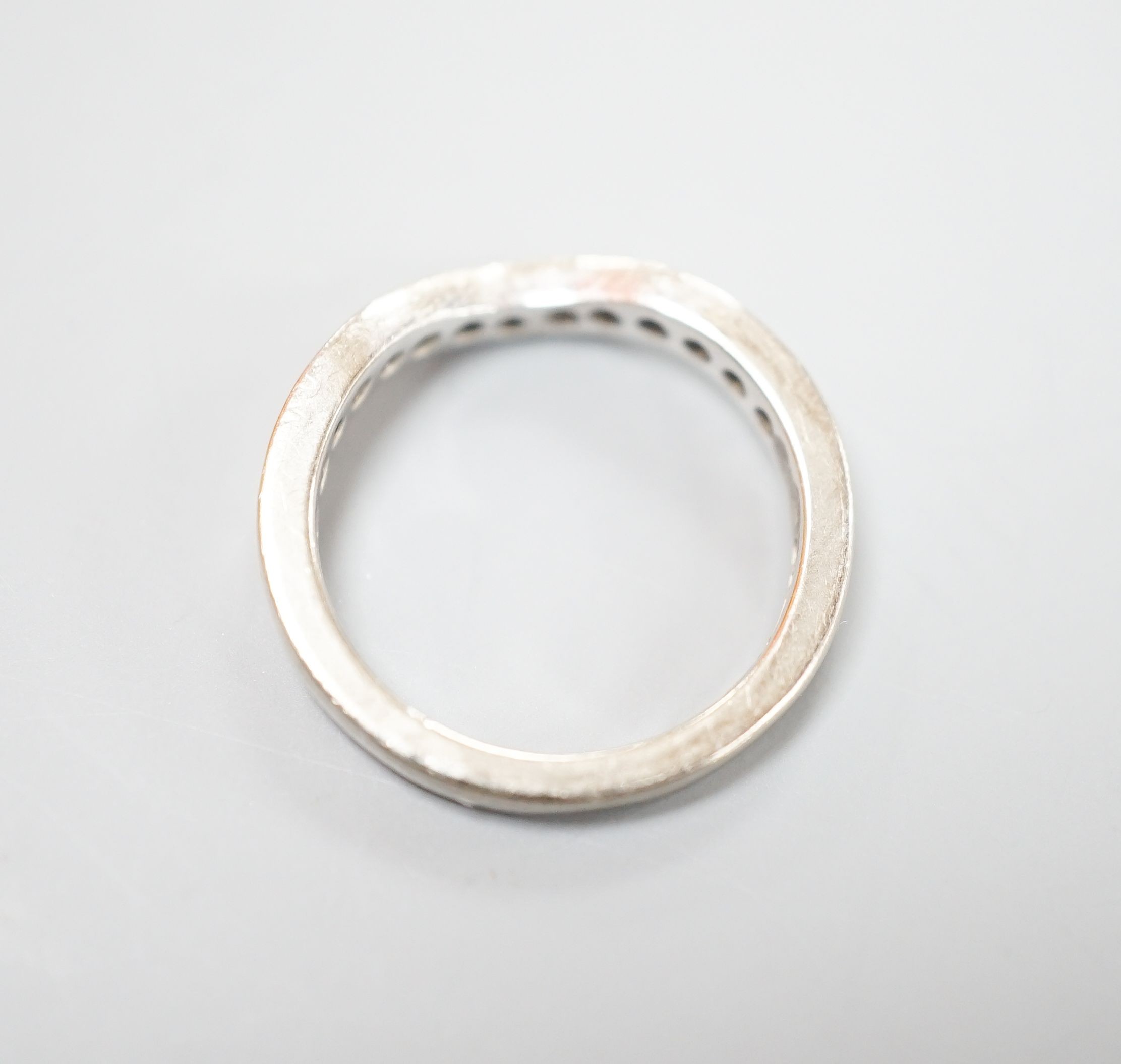 A modern 18ct white gold and diamond set shaped half eternity ring, size H/I, gross weight 3.3 grams.